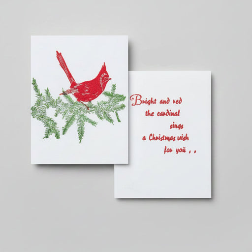 Cardinal linocut illustration on a conifer branch with red text that reads: Bright and red the cardinal sings a Christmas wish for you..