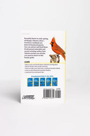 Back cover of a book with a red cardinal illustration and text about birds on a white background