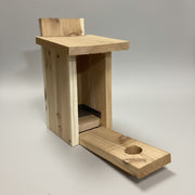 Cedar bluebird box with front panel open for easy cleaning.