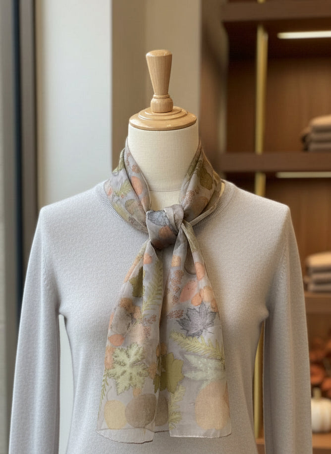 Mannequin wearing a floral scarf with a blurred indoor background