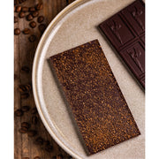 Chocolate Bar - Dark Chocolate with Coffee  - chocolate bars on a plate with coffee beans scattered on the table. 