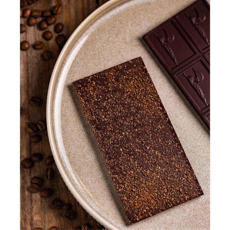 Chocolate Bar - Dark Chocolate with Coffee  - chocolate bars on a plate with coffee beans scattered on the table. 