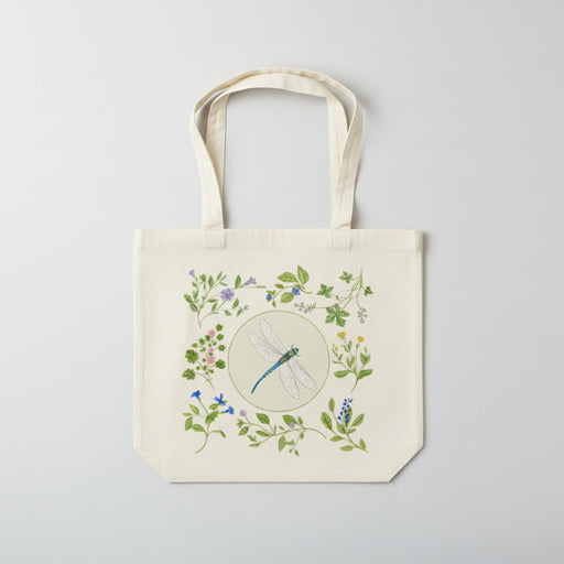 Tote bag with a dragonfly and floral design on a white background