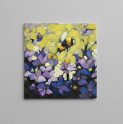 Napkin with an oil paint texture featuring a bumblebee in flight over lavender and yellow flowers 