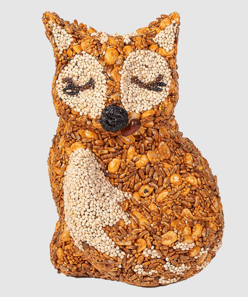 Fox-shaped decorative item made of seeds on a light gray background