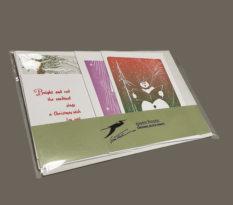Packaged Christmas card with illustrations and text on a gray surface