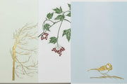 Assortment of cards with nature-themed illustrations: a tree, leaves with berries, and a bird.