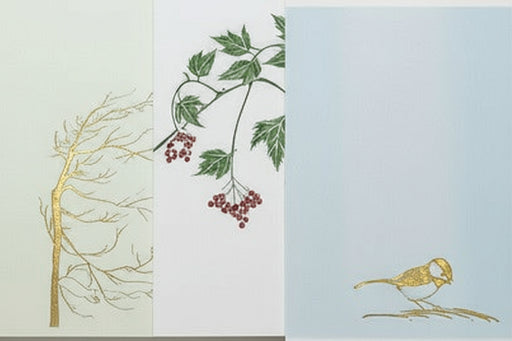 Assortment of cards with nature-themed illustrations: a tree, leaves with berries, and a bird.