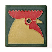 Decorative tile with a rooster design on a green background
