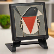 Decorative tile with a red breasted grosbeak design on a stand (Easel not included).