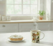 mug of hot coffee and a bagel with cream cheese on a kitchen counter