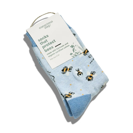 Light blue folded socks with bee pattern and tag on a white background