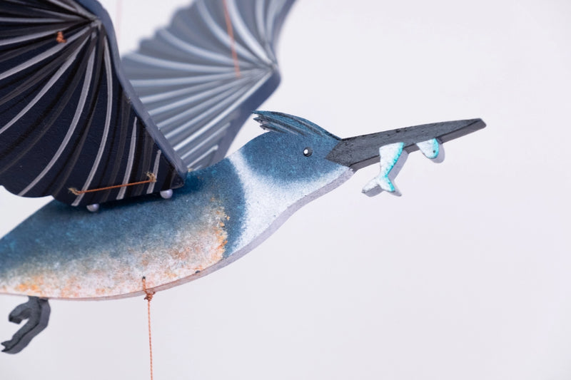 mobile closeup of a kingfisher with fish in his mouth on a white background