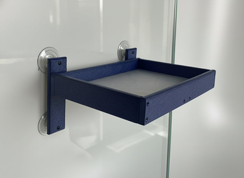 Blue wall-mounted tray on a piece of glass against a white wall 
