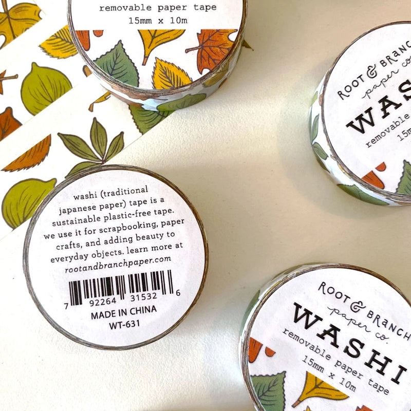 Washi tape with leaf designs and branding on a white background