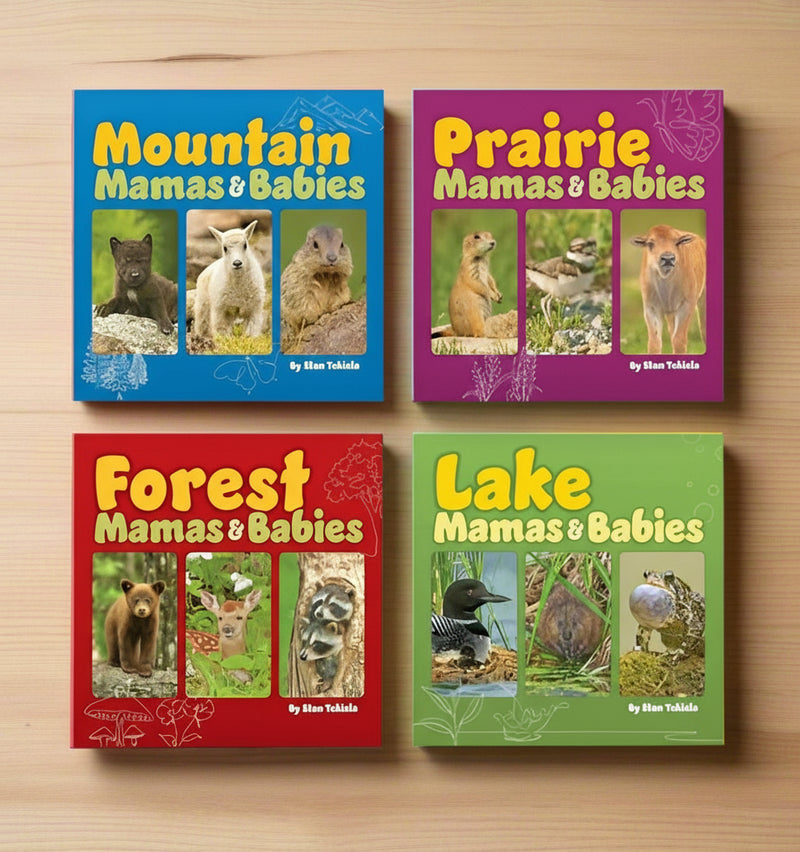 Four children's books titled 'Mountain Mamas & Babies', 'Prairie Mamas & Babies', 'Forest Mamas & Babies', and 'Lake Mamas & Babies' on a light wooden background.