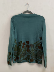 Teal long-sleeve sweater with floral pattern on a hanger against an off-white background - back view