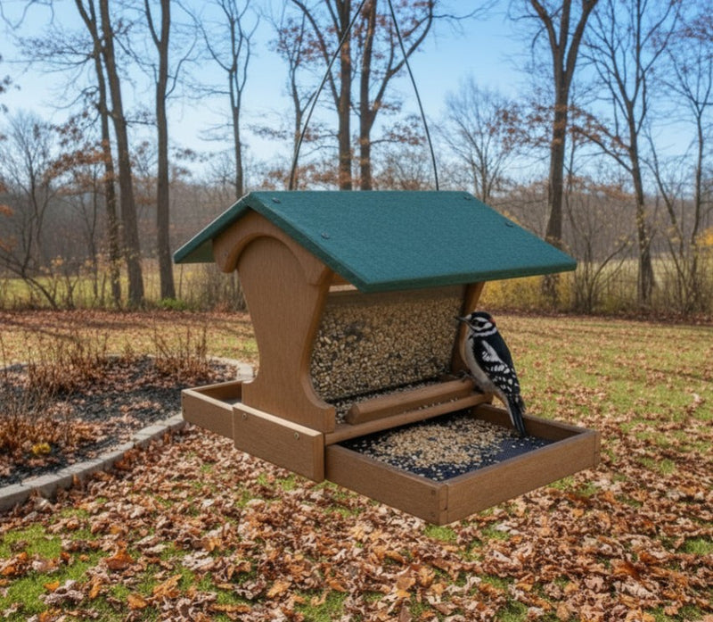 Mini Magnet Hanging Recycled Feeder hanging in a backyard in late autumn. Downy woodpecker enjoying the birdseed