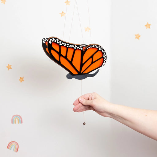 Monarch Butterfly Flying Mobile
hand pulling the mobile pull string