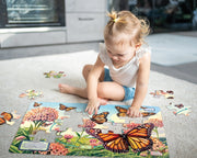 little girl enjoying pieces this puzzle together on a rug