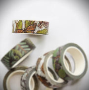 Decorative washi tape roll with monarch butterfly and nature design on a white background