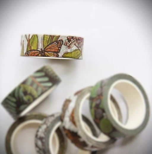 Decorative washi tape roll with monarch butterfly and nature design on a white background