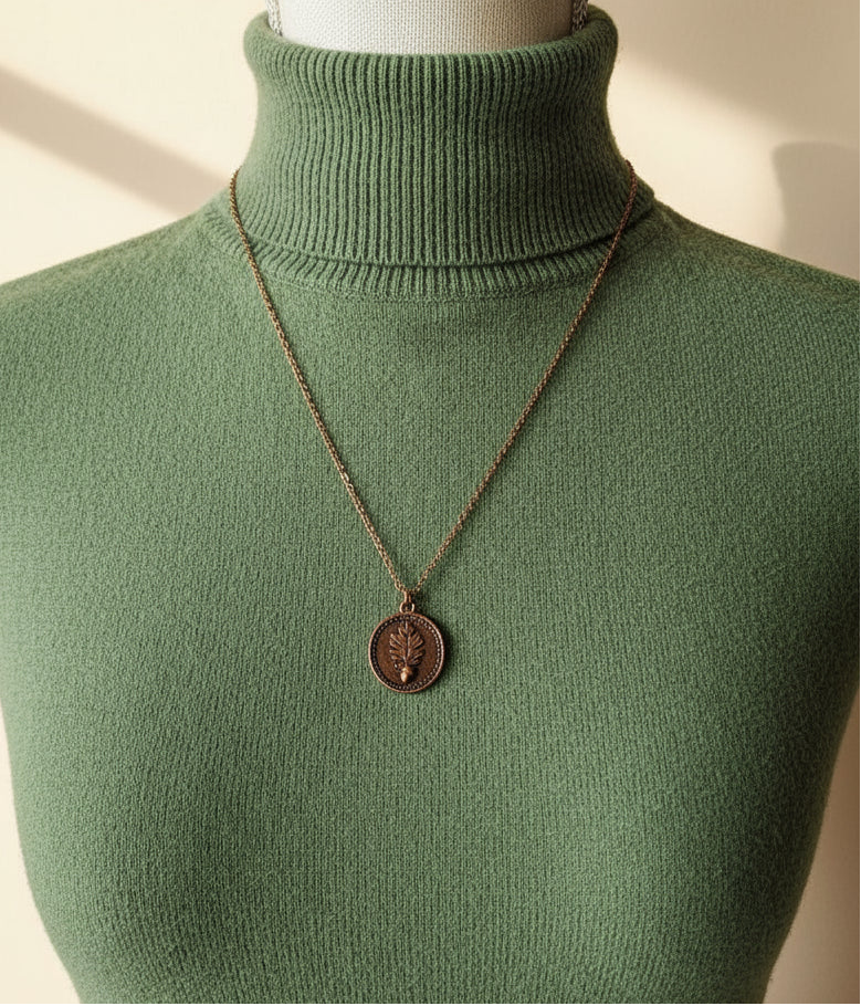Necklace with a pendant on a mannequin bust against a neutral background