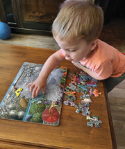 Little kid putting together the Exploring the Seashore Tray Puzzle
