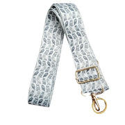 Patterned strap with gold buckle and clasp on a white background
