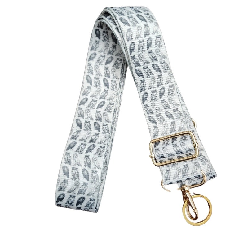 Patterned strap with gold buckle and clasp on a white background
