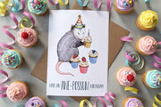 birthday cards surrounded by cupcakes