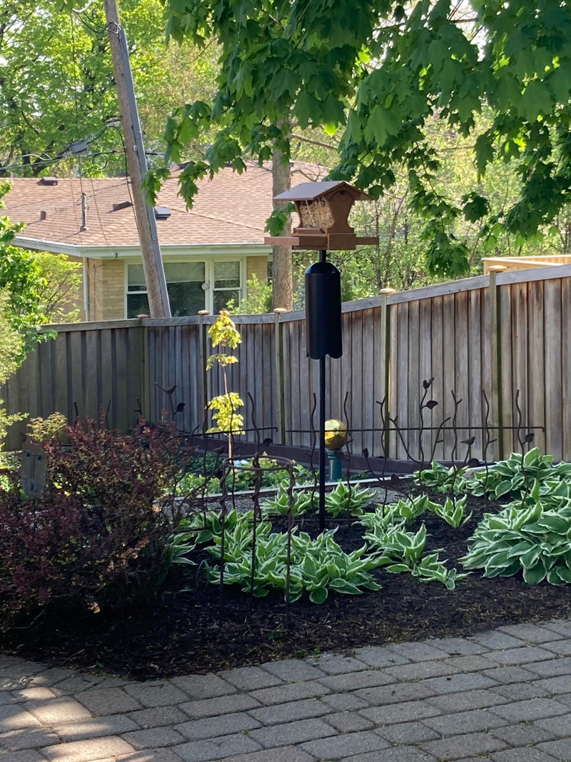 Post-mount mini magnet in all tan mounted on a pole set with dome top squirrel baffle