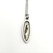 back of silver pendant necklace on a white background