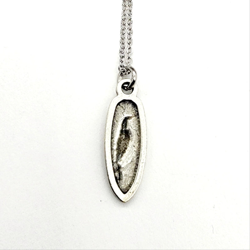 back of silver pendant necklace on a white background