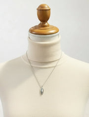Necklace with a pendant on a mannequin bust for sizing scale