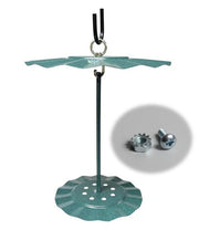 Image of a cylinder seed cake holder hanging with the replacement hardware in an outset circle