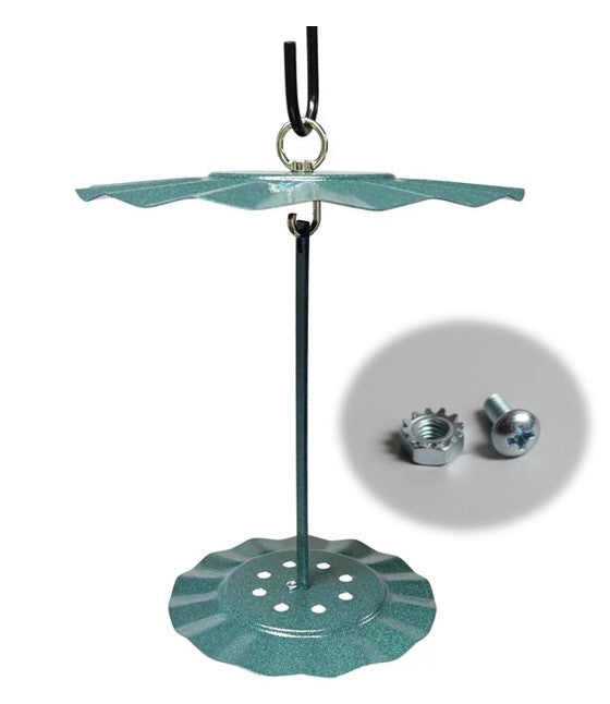 Image of a cylinder seed cake holder hanging with the replacement hardware in an outset circle