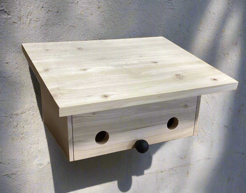 Natural Wood Roosting Box against a neutral outdoor wall