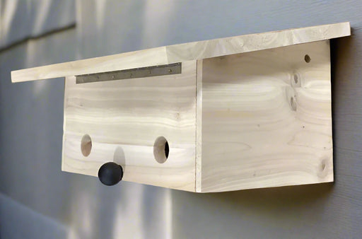 Natural Wood Roosting Box against a neutral outdoor wall