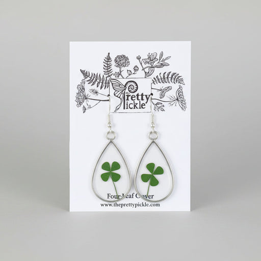 Teardrop-shaped earrings with clover design on a 'The Pretty Pickle' branded card.