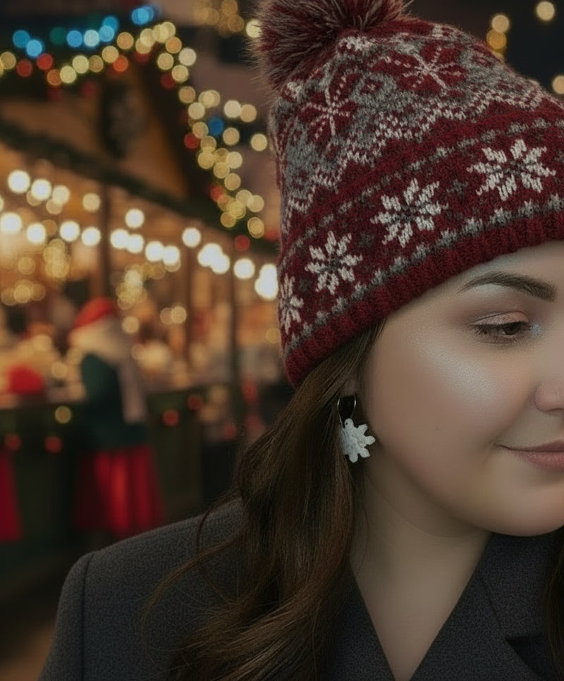 woman with snowflake hoop earrings at a Christmas market