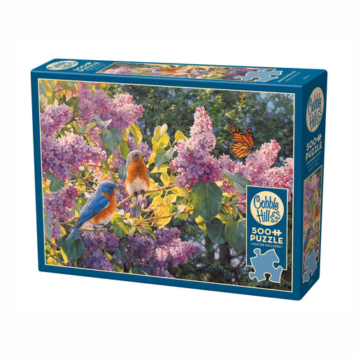 Jigsaw puzzle box with bluebirds and flowers on a white background