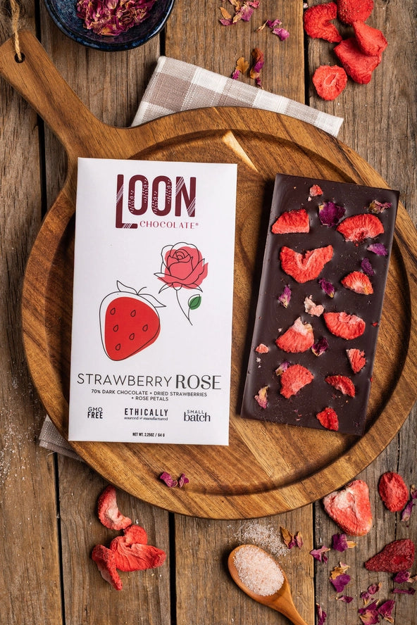 Chocolate Bar - Dark Chocolate with Strawberry-Rose  in packaging and out of packaging on a wood serving platter