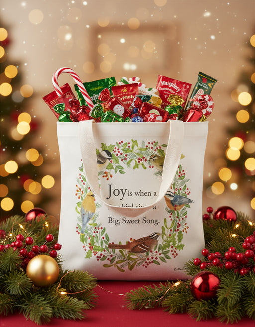 Tote bag with bird design and text on a white background surrounded by festive décor - Candy not included!