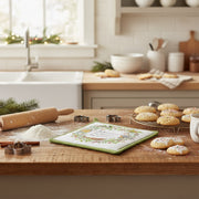 Potholder with birds and holly design, featuring the text 'Joy is when a tiny bird sings a Big, Sweet Song.' festive holiday baking scene