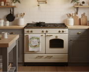 Christmas towel with a wreath and birds hanging on an oven handle for scale. 