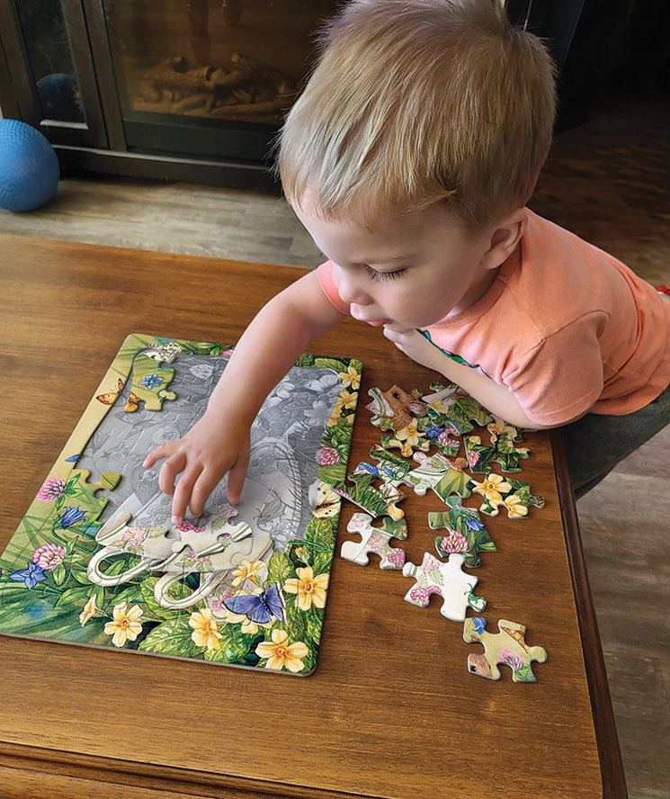 Little Kid piecing together the Tiny Tea Time Tray Puzzle