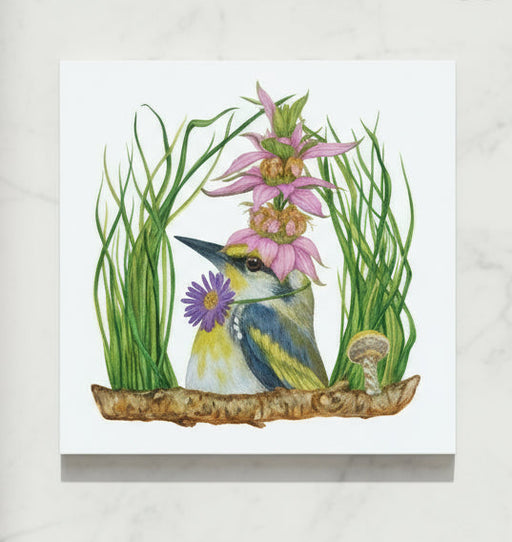 Decorative trivet with a bird and flower design on marble counter top