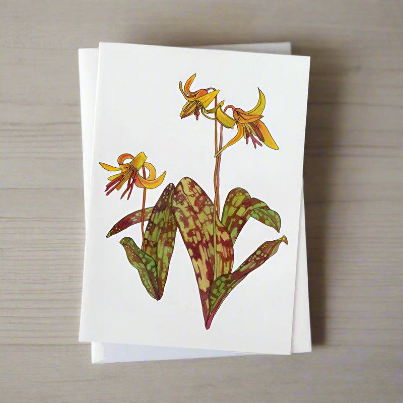 Trout Lily illustrated greeting card on light wood background
