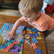 little kid putting together the The Undersea Turtle Tray Puzzle